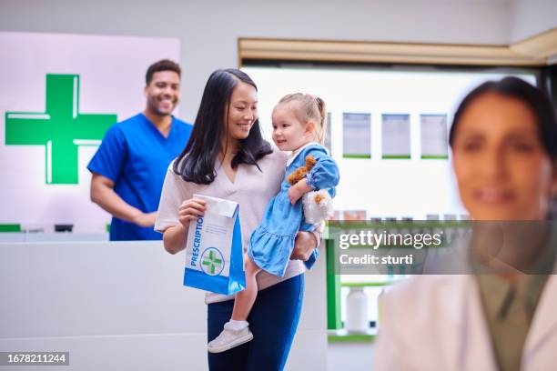 mother and daughter visiting the pharmacy - pharmacy stock pictures, royalty-free photos & images