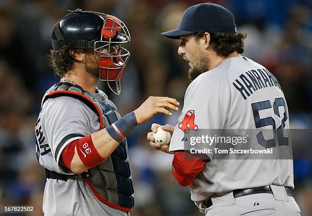 Jarrod Saltalamacchia of the Boston Red Sox talks to Joel Hanrahan during MLB game action against the Toronto Blue Jays on April 30, 2013 at Rogers...