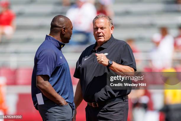 Head Coach Sam Pittman of the Arkansas Razorbacks talks on the field before the game with Head Coach Kenni Burns of the Kent State Golden Flashes at...