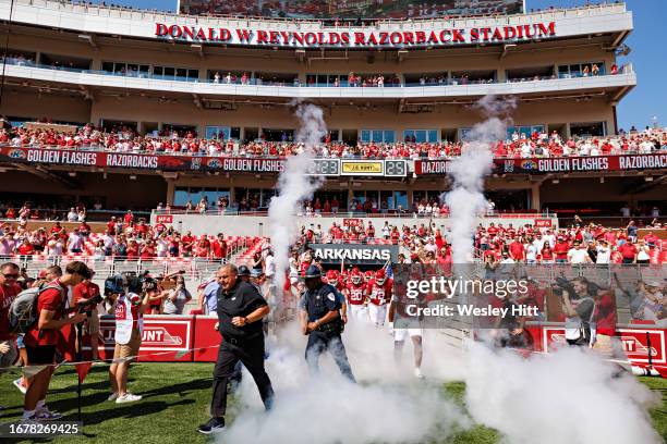 Head Coach Sam Pittman of the Arkansas Razorbacks leads the team onto the field before the game against the Kent State Golden Flashes at Donald W....