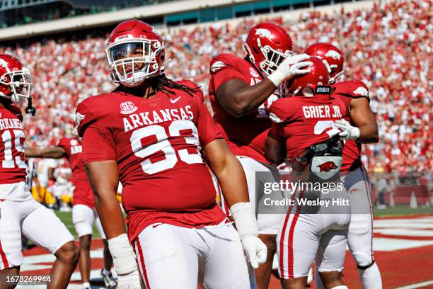 Antonio Grier is congratulated by Keivie Rose of the Arkansas Razorbacks after returning an interception for a touchdown during the game against the...