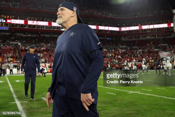 Defensive coordinator Dan Quinn of the Dallas Cowboys stands on the field against the Tampa Bay Buccaneers prior to the NFC Wild Card Playoff game at...