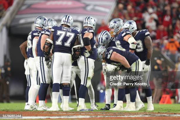 Dallas Cowboys offense in a huddle against the Tampa Bay Buccaneers during the NFC Wild Card Playoff game at Raymond James Stadium on January 16,...