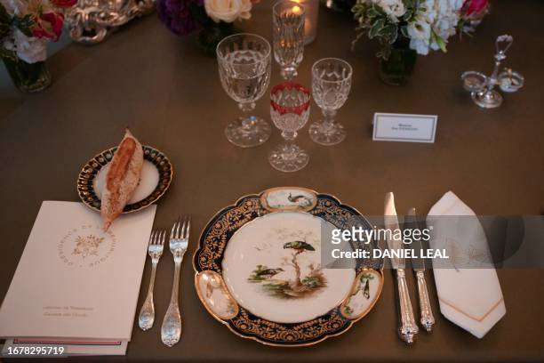 Photo shows a dinner set ahead of a state banquet at the Palace of Versailles, west of Paris, on September 20 on the first day of a British royal...