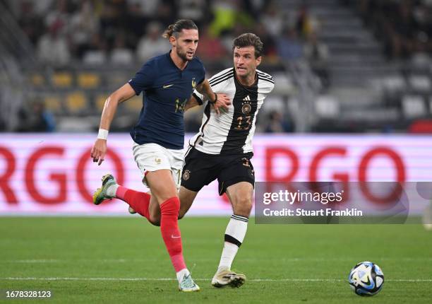 Thomas Müller of Germany is challenged by Adrien Rabiot of France during the international friendly match between Germany and France at Signal Iduna...