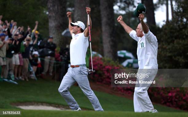 Adam Scott of Australia celebrates after his birdie putt on the second play off hole which saw him win the Green Jacket during the final round of the...