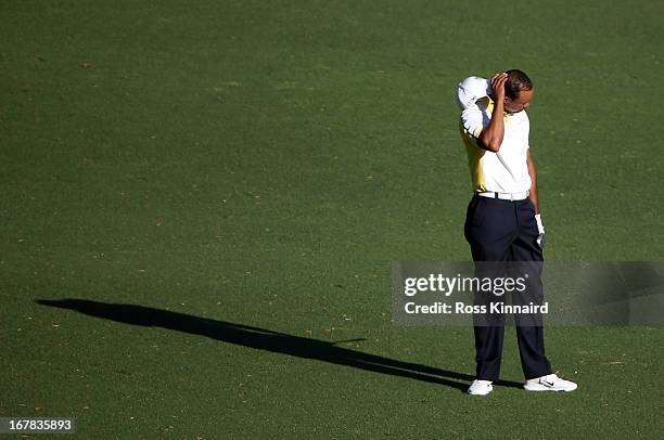 Tiger Woods of the USA reacts to his third shot on the par five 15th hole during the second round of the 2013 Masters at the Augusta National Golf...