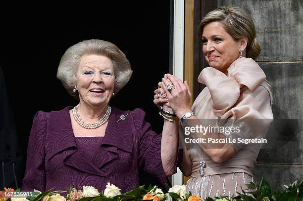 Queen Beatrix of the Netherlands and Queen Maxima appear on the balcony of the Royal Palace to greet the public after her abdication and ahead of the...