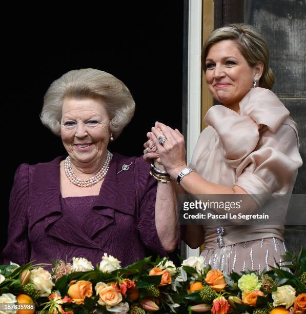 Queen Beatrix of the Netherlands and Queen Maxima appear on the balcony of the Royal Palace to greet the public after her abdication and ahead of the...