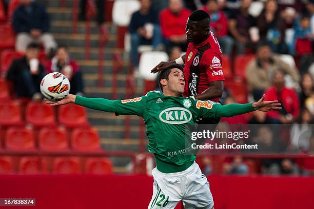 Duvier Riascos of Xolos de Tijuana fights for the ball with Marcelo Ferreira of Palmeiras during a match between Xolos de Tijuana and Palmeiras as...