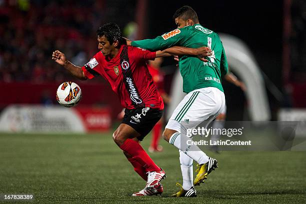 Alfredo Moreno of Xolos de Tijuana fights for the ball with Mauricio Ramos of Palmeiras during a match between Xolos de Tijuana and Palmeiras as part...