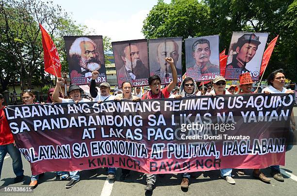 Protestors march towards the United States Embassy on May 1, 2013 in Manila, Philippines. Philippine workers unions gather in the streets of Manila...