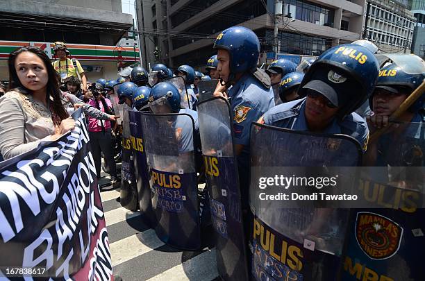 Protestors are stopped by anti riot police during their march towards the United States Embassy on May 1, 2013 in Manila, Philippines. Philippine...