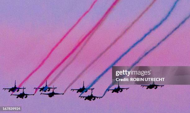 Aircrafts of the Dutch Royal Airforce fly over the IJ lake in Amsterdam, The Netherlands, on April 30 at the end of the King's boat trip. AFP PHOTO /...