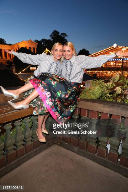 Nina Meise and her twin sister Julia Meise during the 188th Oktoberfest at Käferzelt on September 20, 2023 in Munich, Germany.