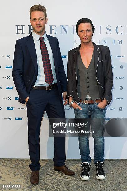 Mister Germany 2013 Joern Kamphuis and singer Marcel Gabriel attend the premiere of the documentary 'Allein im Licht' at the Babylon cinema on April...