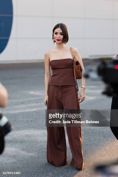 Guest is seen wearing a brown top and brown pant outside the COS show during New York Fashion Week on September 12, 2023 in New York City.
