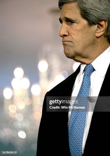 Secretary of State John Kerry listens to the President of Georgia Mikheil Saakashvili speak to journalists following a bilateral meeting at the U.S....