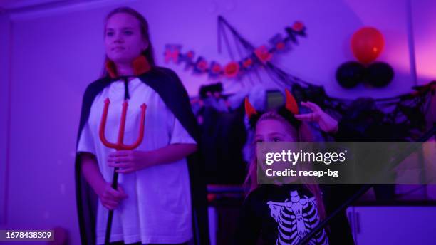 mother and daughter enjoying dancing and live streaming during halloween in living room at home - live action role playing bildbanksfoton och bilder