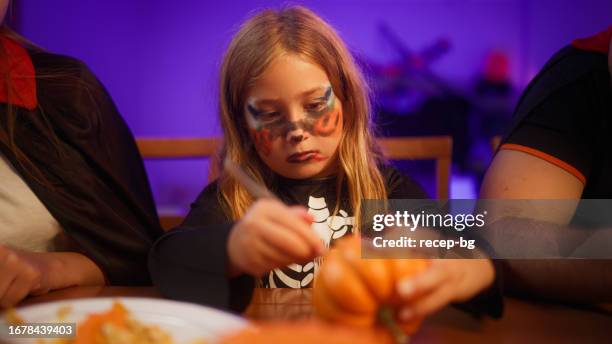 small girl making jack o' lantern at home - halloween craft stock pictures, royalty-free photos & images