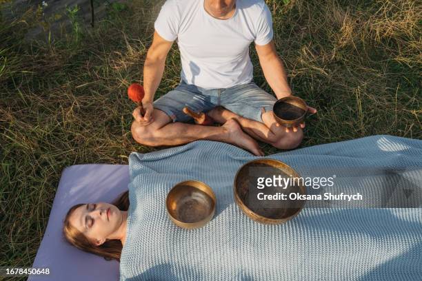 singing bowls meditation outdoor at the sunset - concentration camp stock pictures, royalty-free photos & images