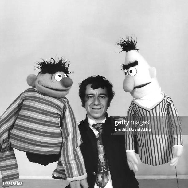 Photographer David Attie holding muppets Ernie and Bert during the making of Sesame Street's very first season, at Reeves TeleTape Studio on March...