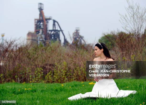 La comédienne Audrey Vernon fête le travail à Florange" -- French actress Audrey Vernon poses in front of the ArcelorMittal blast furnaces in...