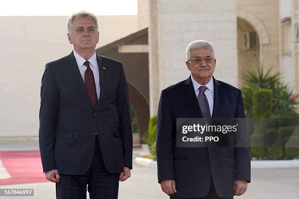 In this handout image supplied by office of the Palestinian President, President Mahmoud Abbas welcomes Serbian President Tomislav Nikolic on May 1,...