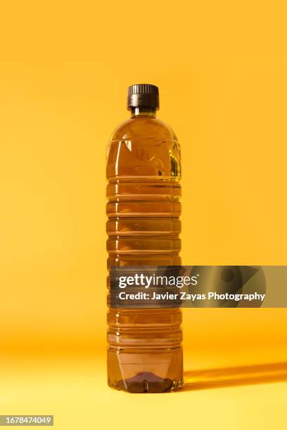 one liter olive oil bottle on yellow background - liter stock pictures, royalty-free photos & images