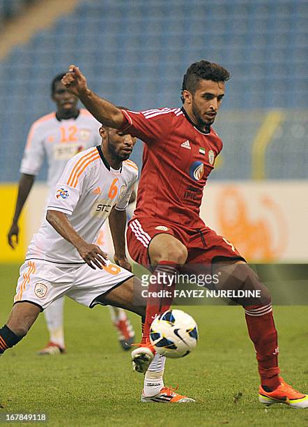 Al-Jazira player Ali Ahmed controls the ball in front of Saudi Arabia's al-Shabab club player Omar Alghamdi during their AFC Champions League group A...