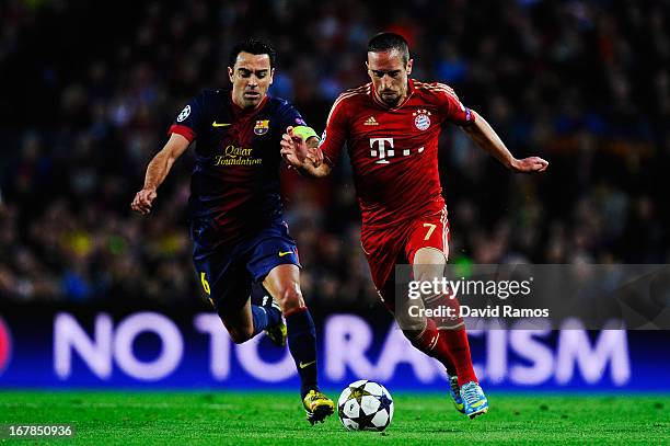 Xavi Hernandez of Barcelona and Franck Ribery of Munich challenge for the ball during the UEFA Champions League semi final second leg match between...