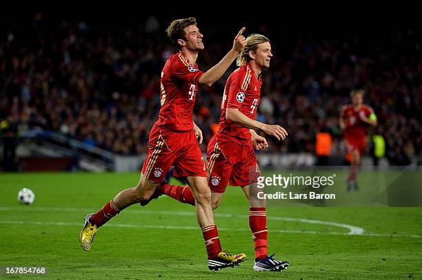 Thomas Muller of Munich celebrates with teammate Anatoliy Tymoshchuk after scoring his team's third goal during the UEFA Champions League semi final...