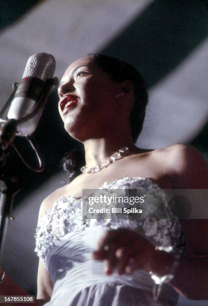 Jazz and blues singer Billie Holiday performs at the Newport Jaszz festival on July 6, 1957 in Newport, Rhode Island.