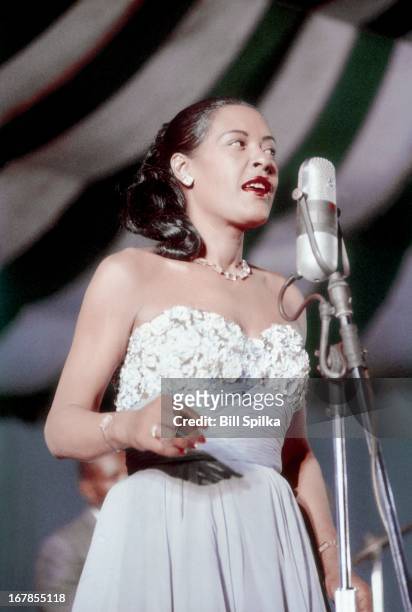 Jazz and blues singer Billie Holiday performs at the Newport Jaszz festival on July 6, 1957 in Newport, Rhode Island.
