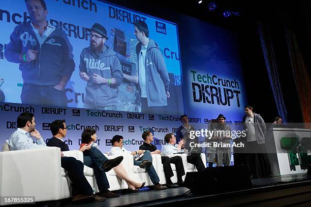 Judges Nancy Peretsman, Chi-Hua Chien, Roelof Botha and Michael Arrington watch Glide present onstage at TechCrunch Disrupt NY 2013 at The Manhattan...