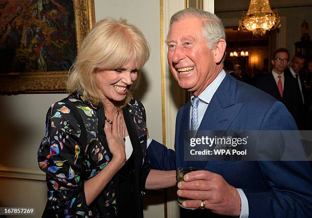 Prince Charles, Prince of Wales greets actress Joanna Lumley as he hosts a reception to mark the 60th anniversary of the charity 'Samaritans', at...