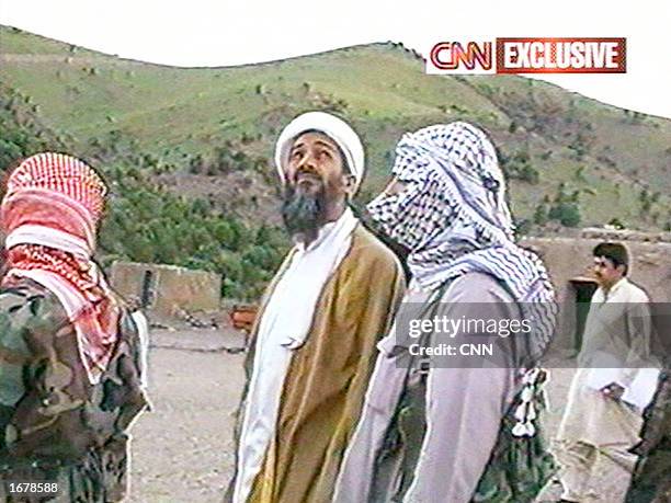 This image taken from a collection of videotapes obtained by CNN shows Saudi terrorist suspect Osama bin Laden and his unidentified body guards...