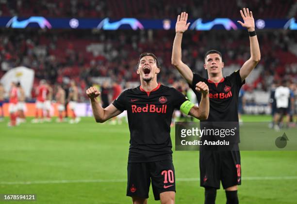 Amar Dedic and Petar Ratkov of Salzburg celebrate their victory at the end of the UEFA Champions League match between SL Benfica vs RB Salzburg at...