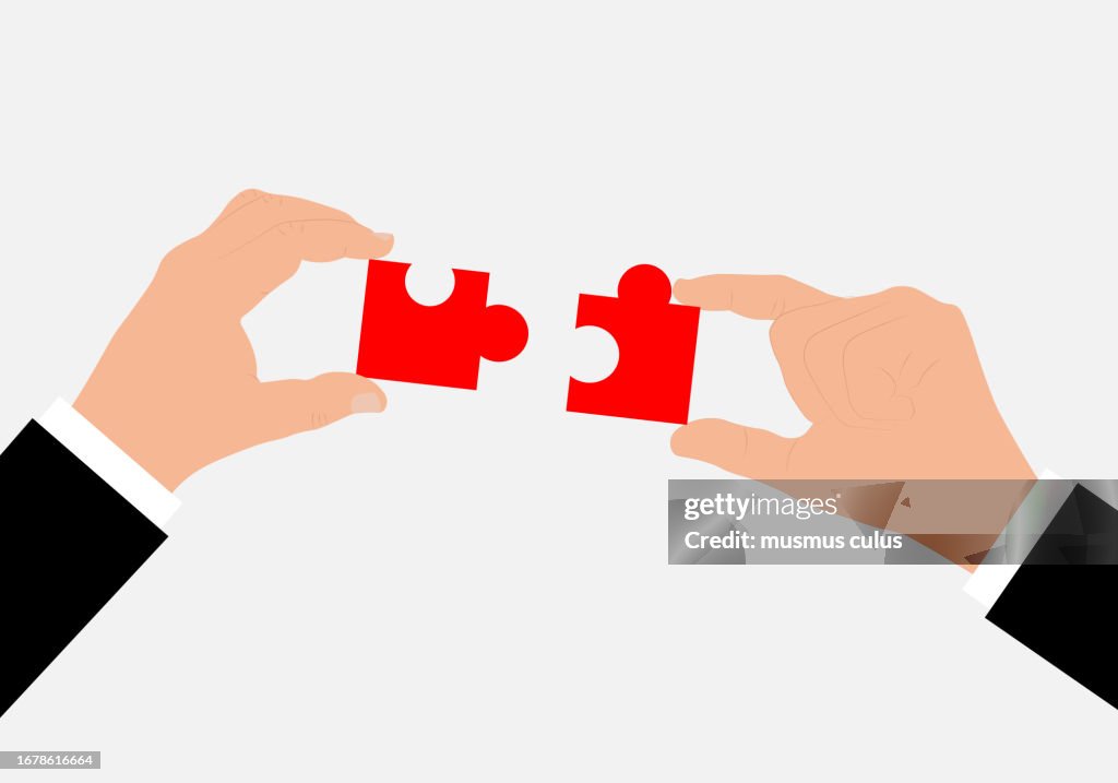 Working together, hands combining puzzle pieces, teamwork