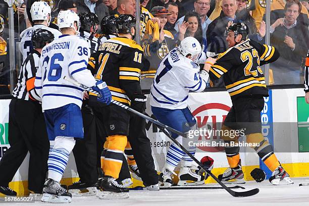 Chris Kelly of the Boston Bruins fights against Leo Komarov of the Toronto Maple Leafs in Game One of the Eastern Conference Quarterfinals during the...