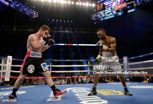 Austin Trout squares up with Canelo Alvarez of Mexico during the WBC, WBA, and Vacant Ring Magazine Super Welterweight Title Fight at Alamodome on...