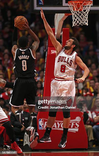 Marco Belinelli of the Chicago Bulls defends against MarShon Brooks of the Brooklyn Nets in Game Three of the Eastern Conference Quarterfinals during...