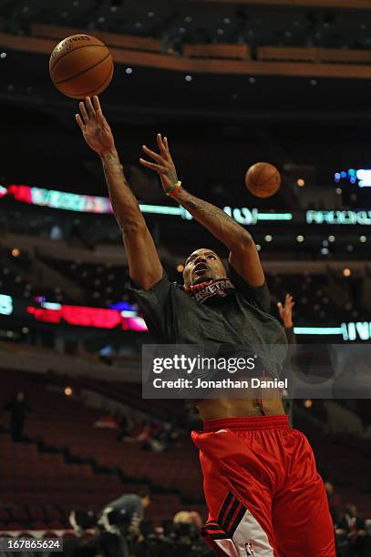 Derrick Rose of the Chicago Bulls participates in warm-ups before Game Three of the Eastern Conference Quarterfinals against the Brooklyn Nets during...