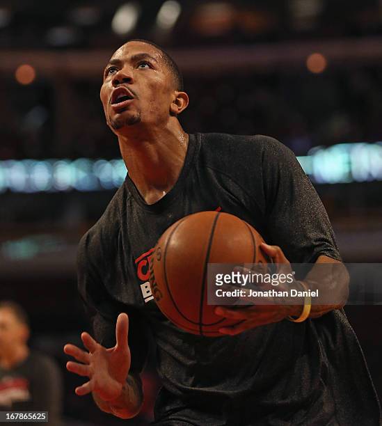 Derrick Rose of the Chicago Bulls participates in warm-ups before Game Three of the Eastern Conference Quarterfinals against the Brooklyn Nets during...