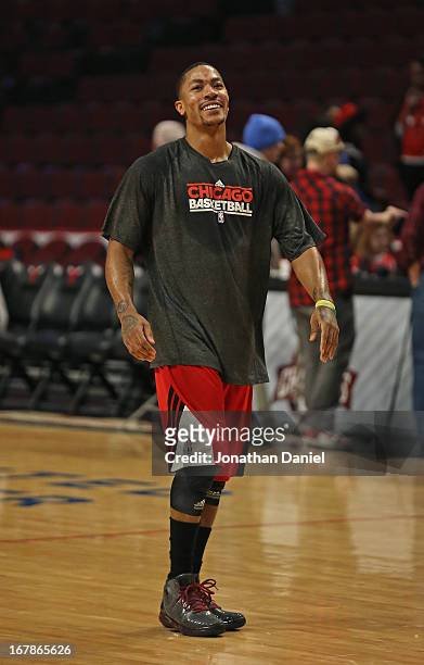 Derrick Rose of the Chicago Bulls participates in warm-ups before Game Three of the Eastern Conference Quarterfinals against the Brooklyn Nets during...