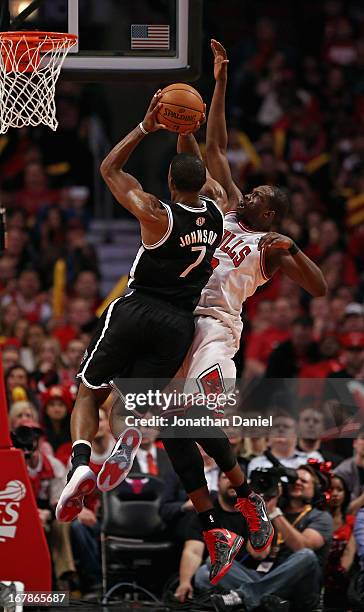 Joe Johnson of the Brooklyn Nets shoots against Loul Deng of the Chicago Bulls in Game Three of the Eastern Conference Quarterfinals during the 2013...