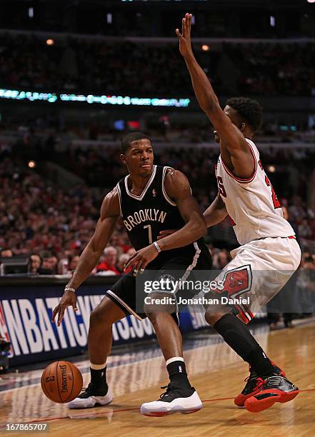 Joe Johnson of the Brooklyn Nets moves against Jimmy Butler of the Chicago Bulls in Game Three of the Eastern Conference Quarterfinals during the...