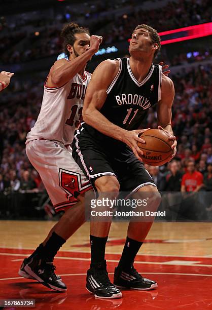 Brook Lopez of the Brooklyn Nets moves against Joakim Noah of the Chicago Bulls in Game Three of the Eastern Conference Quarterfinals during the 2013...