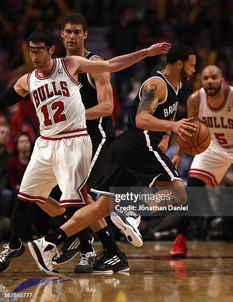 Deron Williams of the Brooklyn Nets drives around Kirk Hinrich of the Chicago Bulls in Game Three of the Eastern Conference Quarterfinals during the...