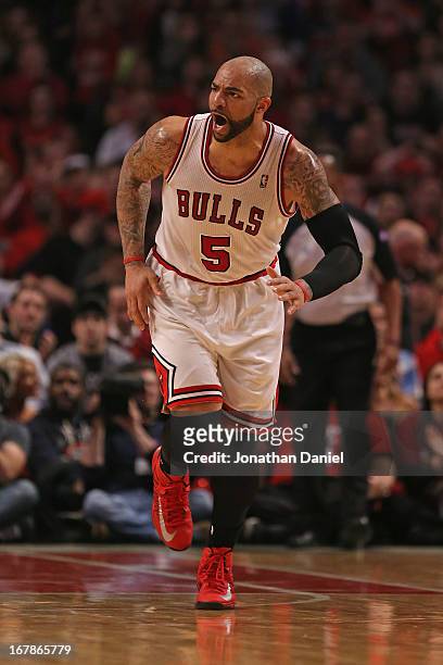Carlos Boozer of the Chicago Bulls celebrates a shot against the Brooklyn Nets in Game Three of the Eastern Conference Quarterfinals during the 2013...